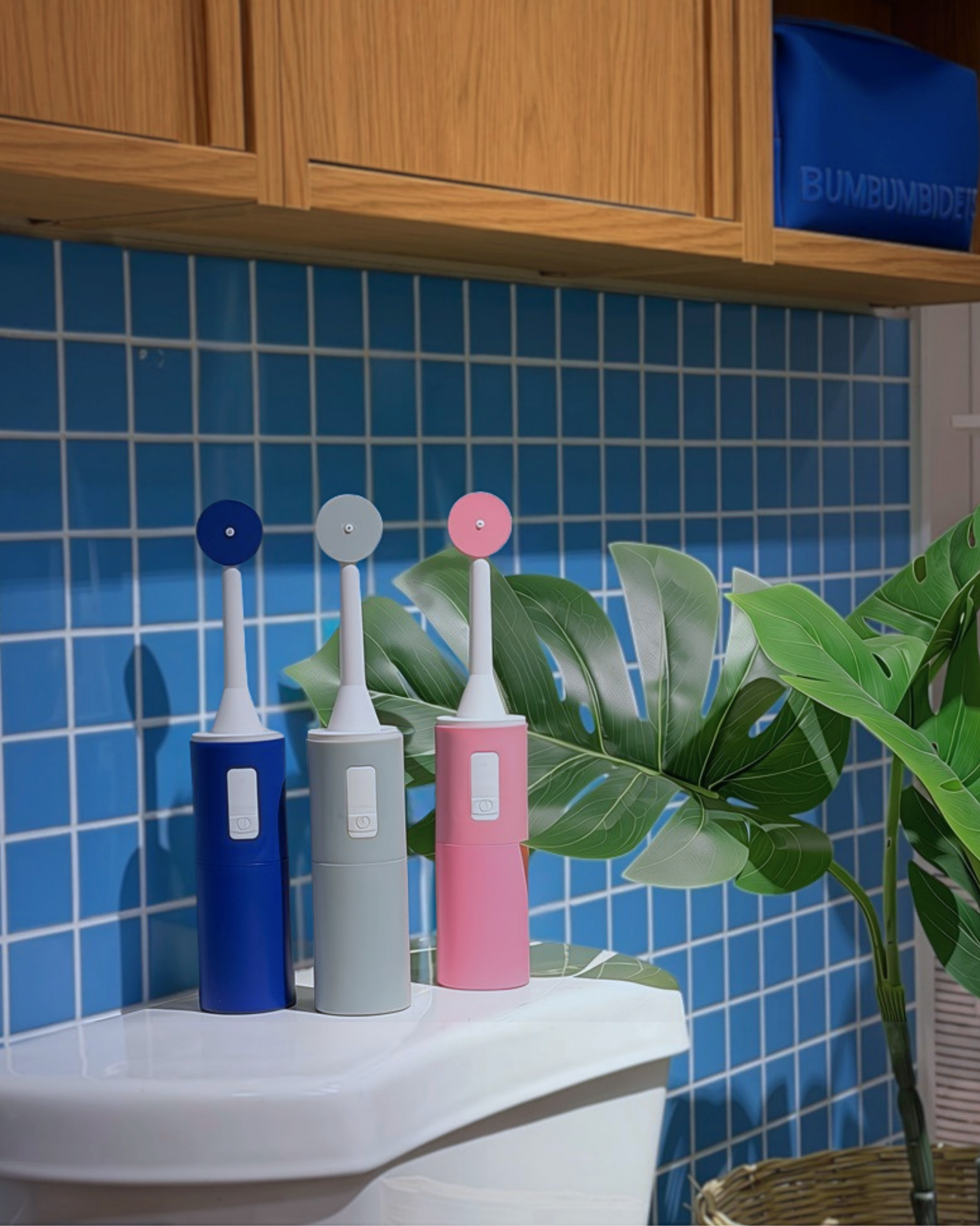Portable bidet in blue, gray, and pink color options on toilet